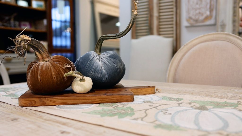 Velvet pumpkins in brown, blue, and cream add to the colors that Amitha Verma is using in her simple farmhouse fall table makeover.
