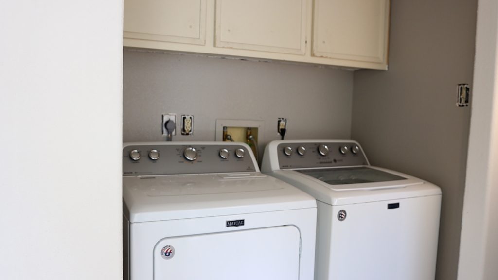 The laundry room on the opposite side of the bad kitchen layout that Amitha Verma is renovating only has space for the washer and dryer.